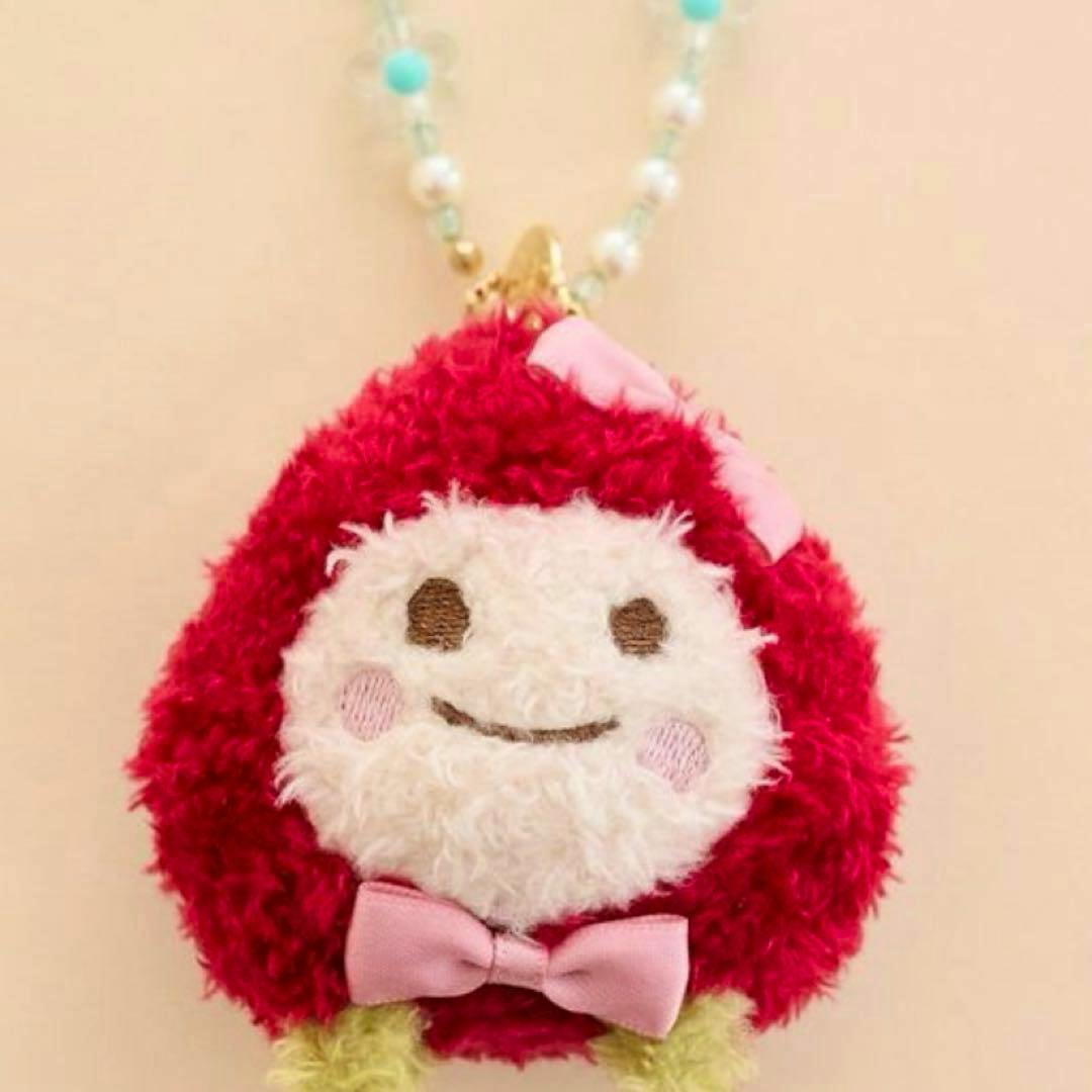 Plush strawberry-themed keychain charm with a smiling face, pink bow, and a beaded chain.