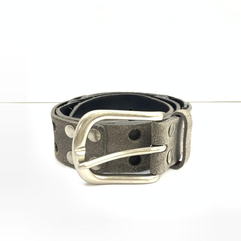 A gray suede studded belt with a metal buckle rolled on a white background.
