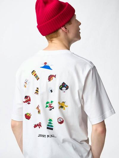 Model shown from behind wearing a white cotton graphic T-shirt with colorful pixel-style designs on the back.