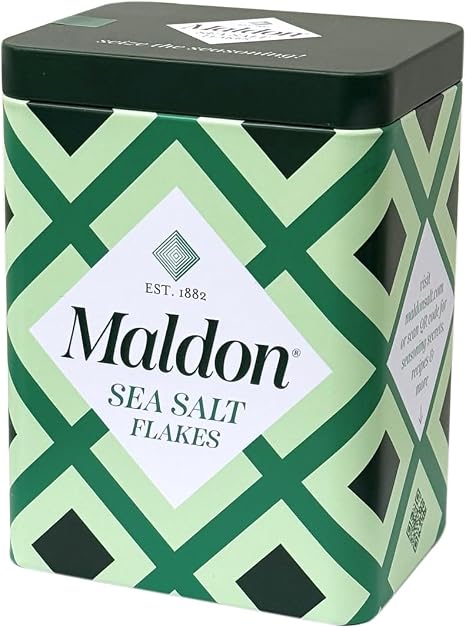 A green patterned metal canister labeled for Mardon sea salt flakes.