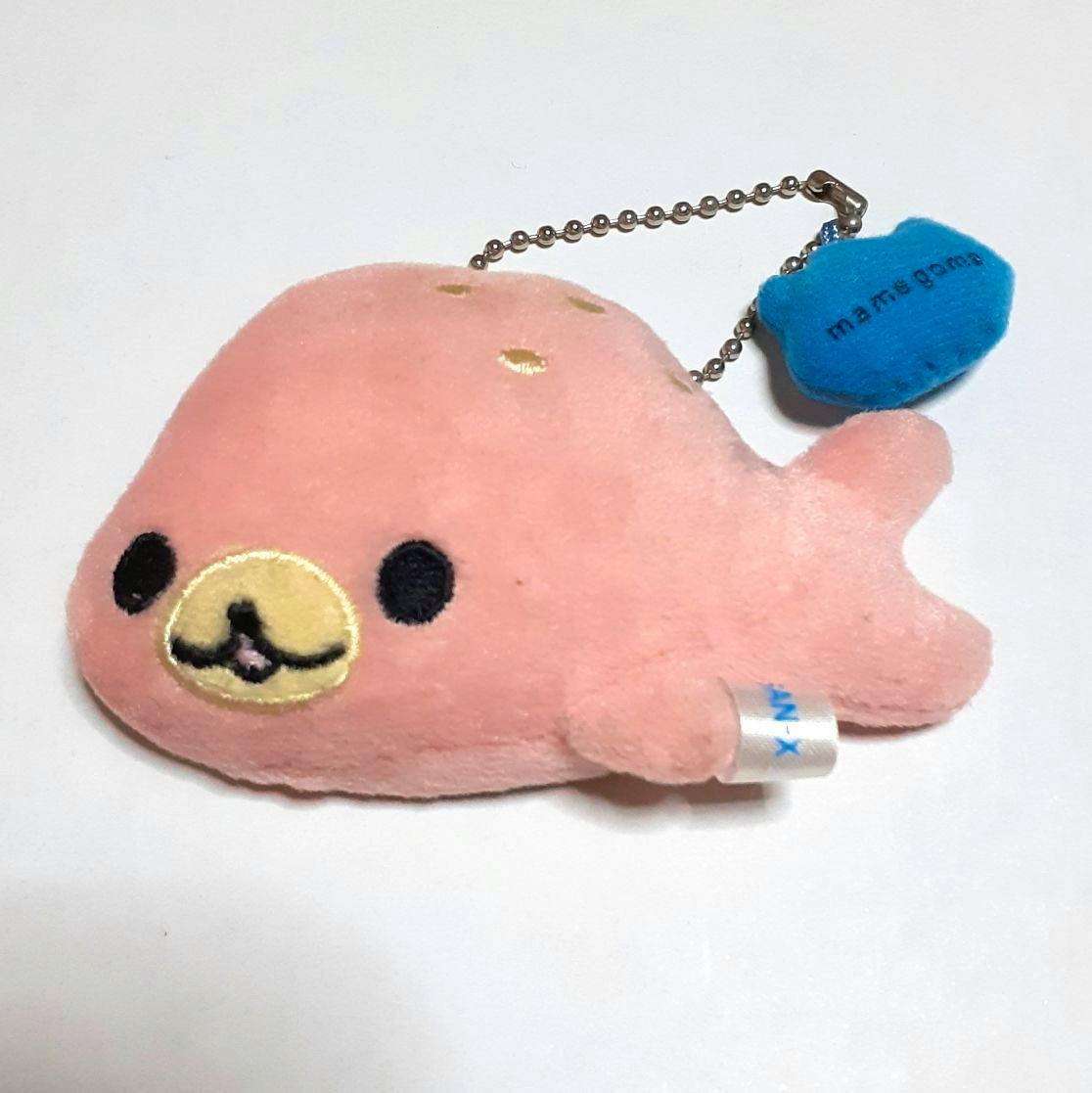 Pink まめゴマ plush keychain mascot with a ball chain and small blue tag on a white background.