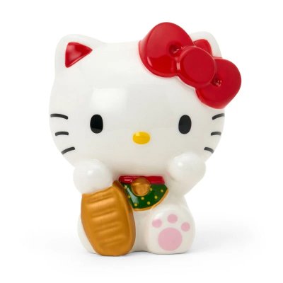Front view of a white ceramic maneki‑neko coin bank with a red bow and a gold coin.