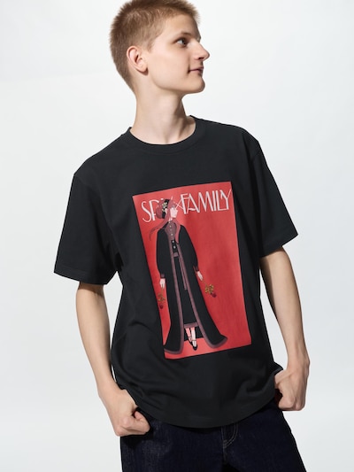 A male model wearing the black Manga UT Black Clover men's cotton T-shirt showing a red rectangular character graphic on the front.
