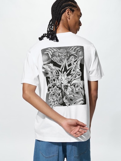 Rear view of a white cotton T-shirt worn by a model showing a large black-and-white manga-style back graphic.