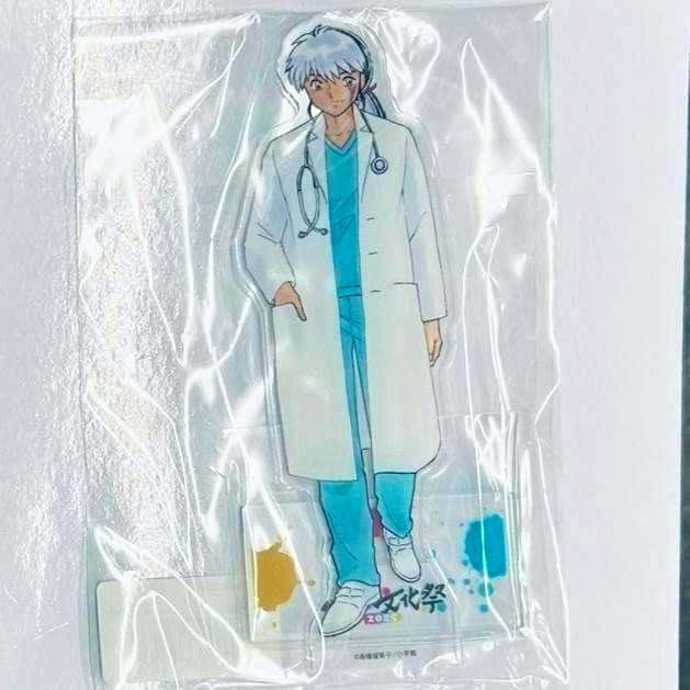 Packaged 摩緒 acrylic stand showing the character in a white lab coat and blue scrubs standing on a base labeled サンデー文化祭2025.