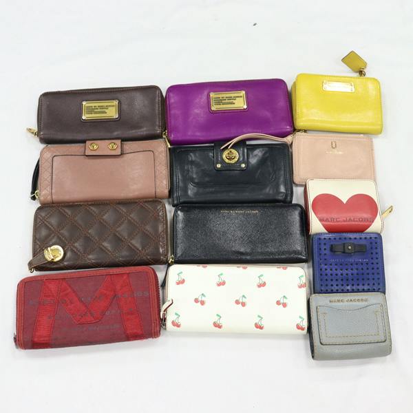 Thirteen Marc Jacobs wallets and small leather goods arranged on a white background.
