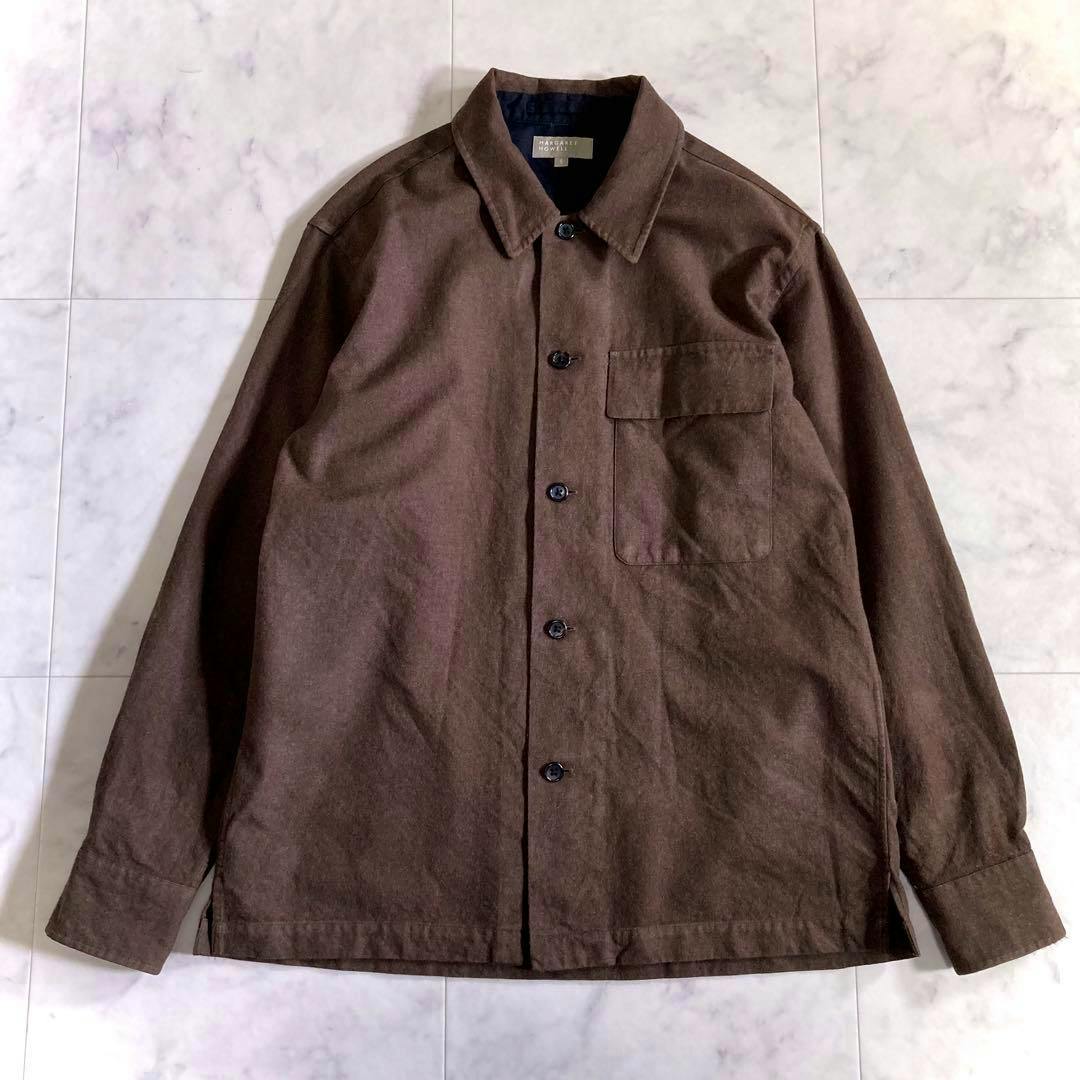 Front view of the Margaret Howell brown wool-cotton long-sleeve shirt laid flat showing buttons and a chest pocket.