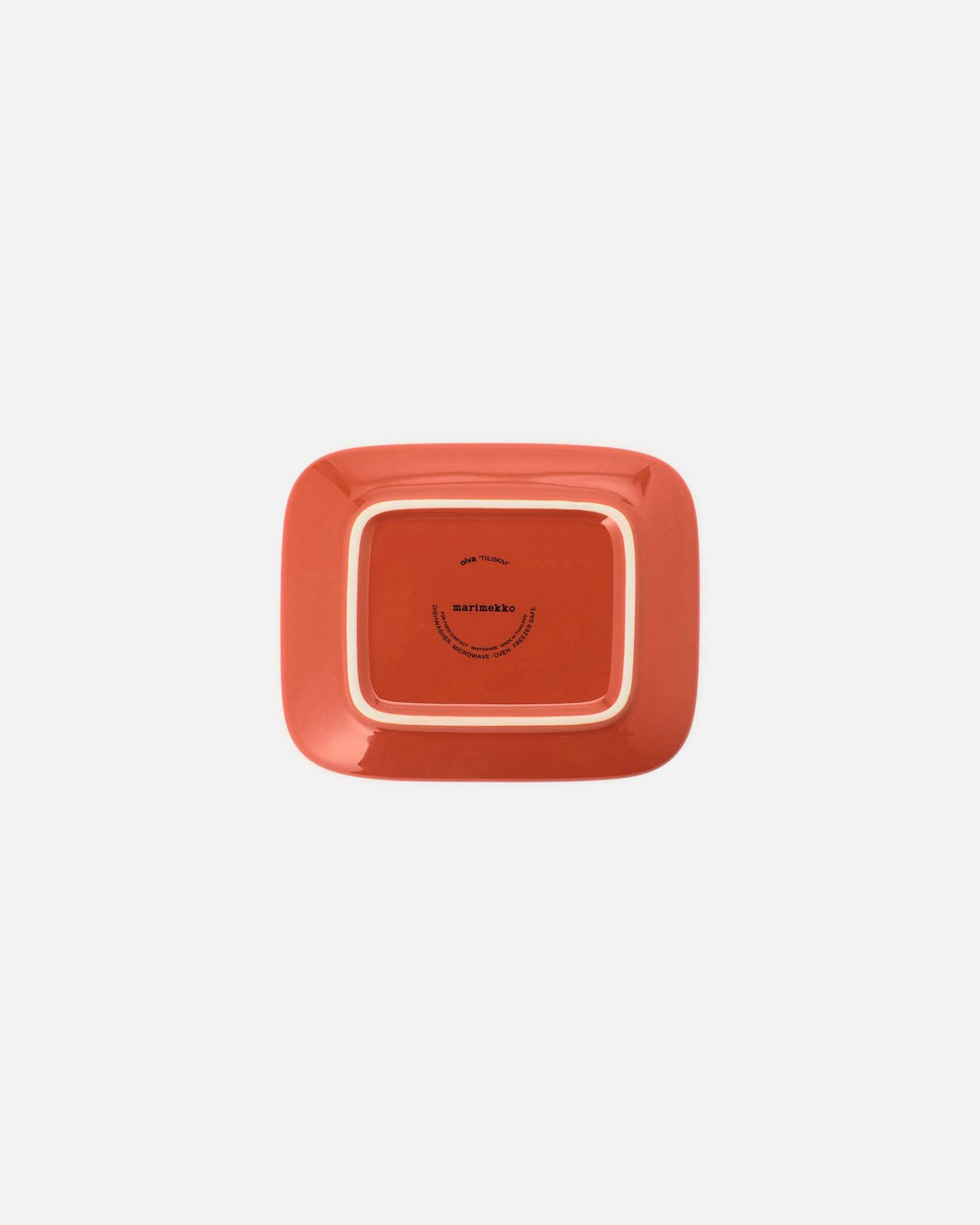 Underside of an orange square ceramic plate showing the brand text.