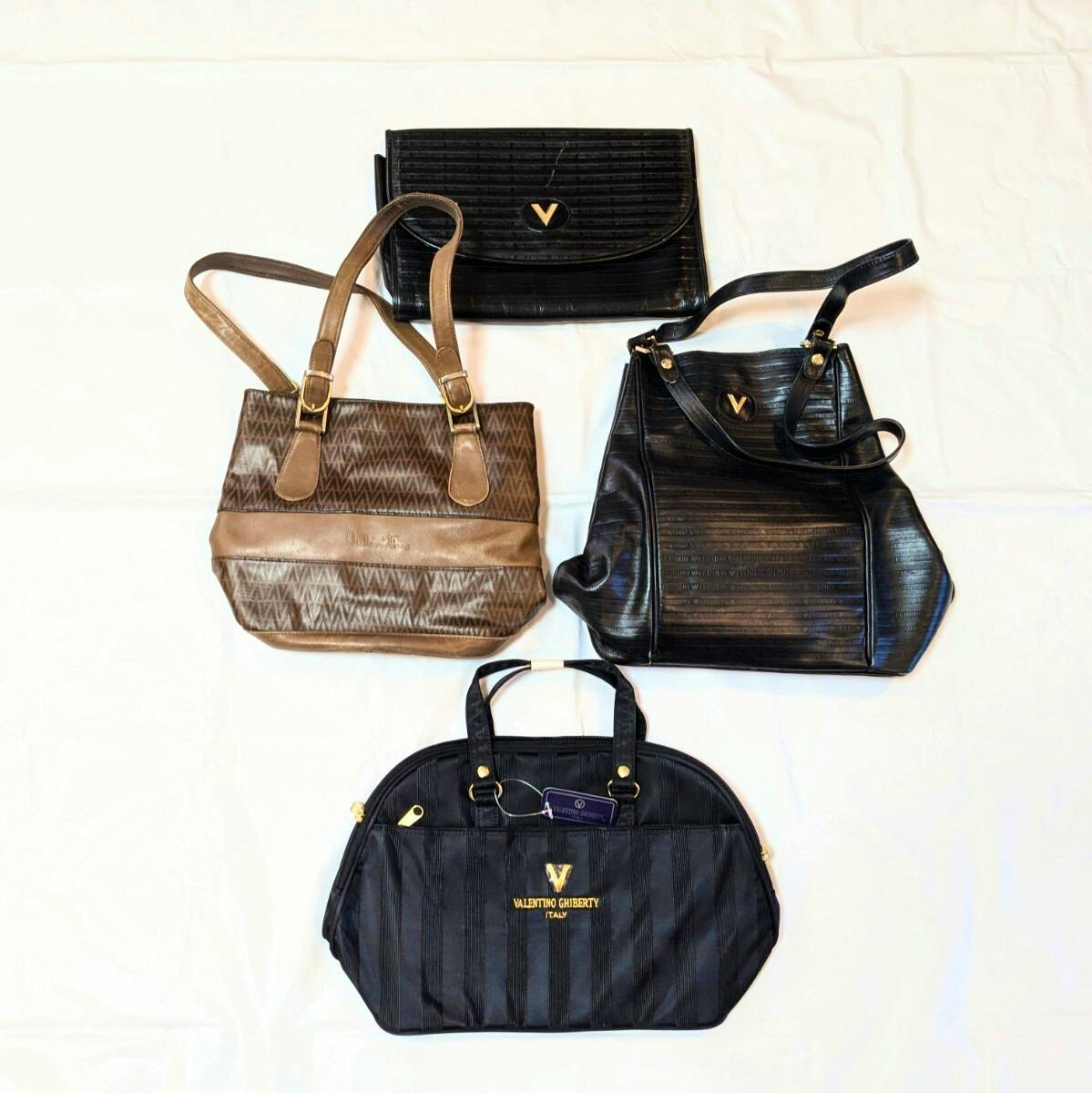 Four VALENTINO GHIBERTY bags (one brown, three black) arranged on a white background.