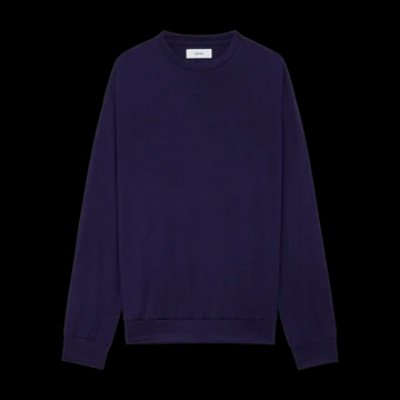 Dark purple wool crew neck sweater laid flat on a black background.