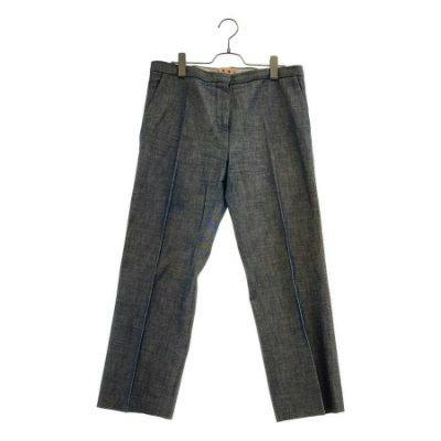 Full-length gray denim-like women's slacks hanging on a hanger against a white background.