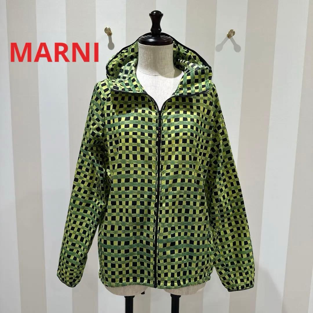 Front view of a green and black check-patterned nylon hooded jacket on a mannequin with the zipper closed.