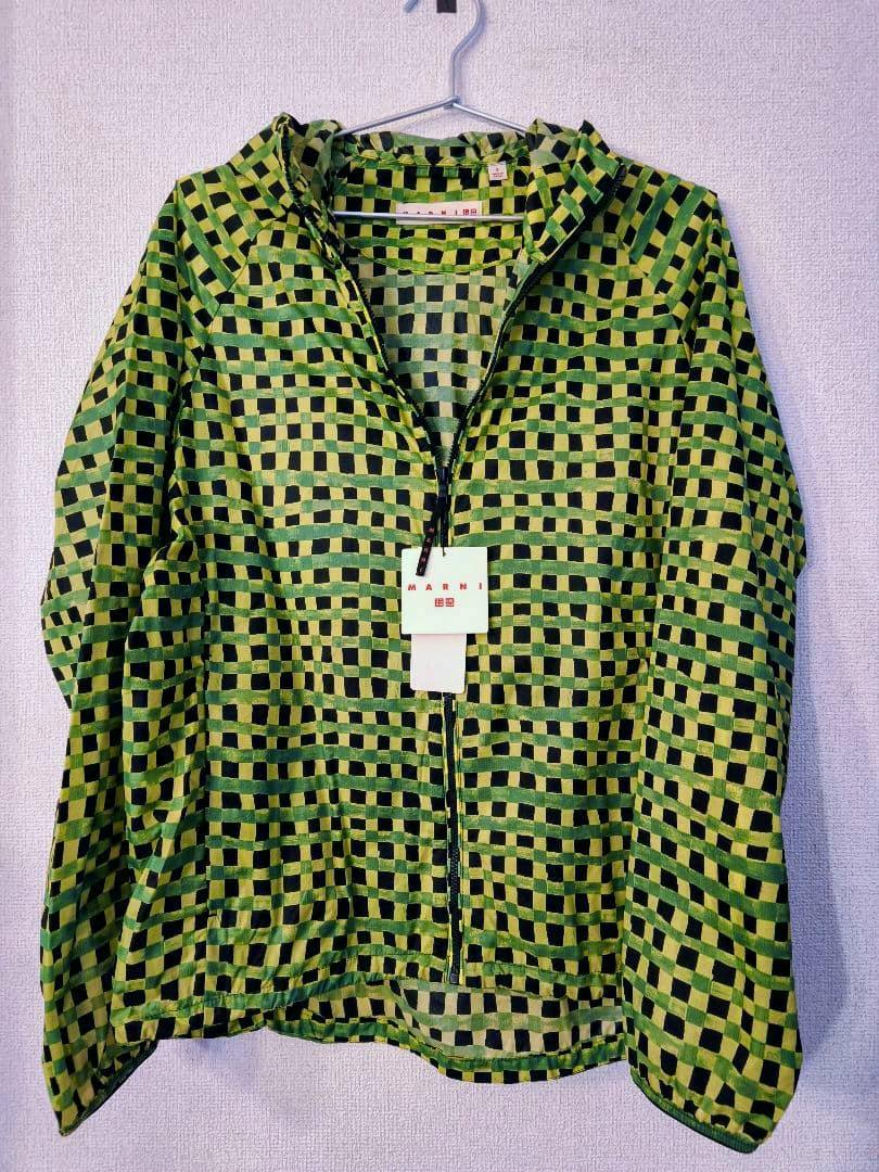 Front view of a green and black checked MARNI UNIQLO packable parka (men's nylon jacket) with tags hanging on a hanger.