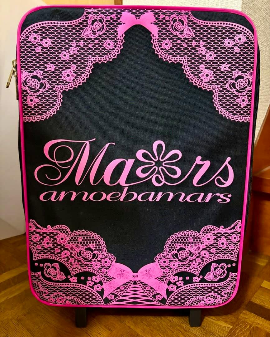 Front view of a black canvas suitcase with a pink lace-print design and the word "Mars" printed on the front.