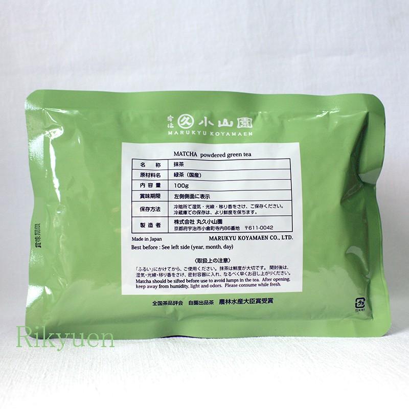 Green sealed pouch of matcha powdered green tea (100g) showing the product label with Japanese text on a white background.