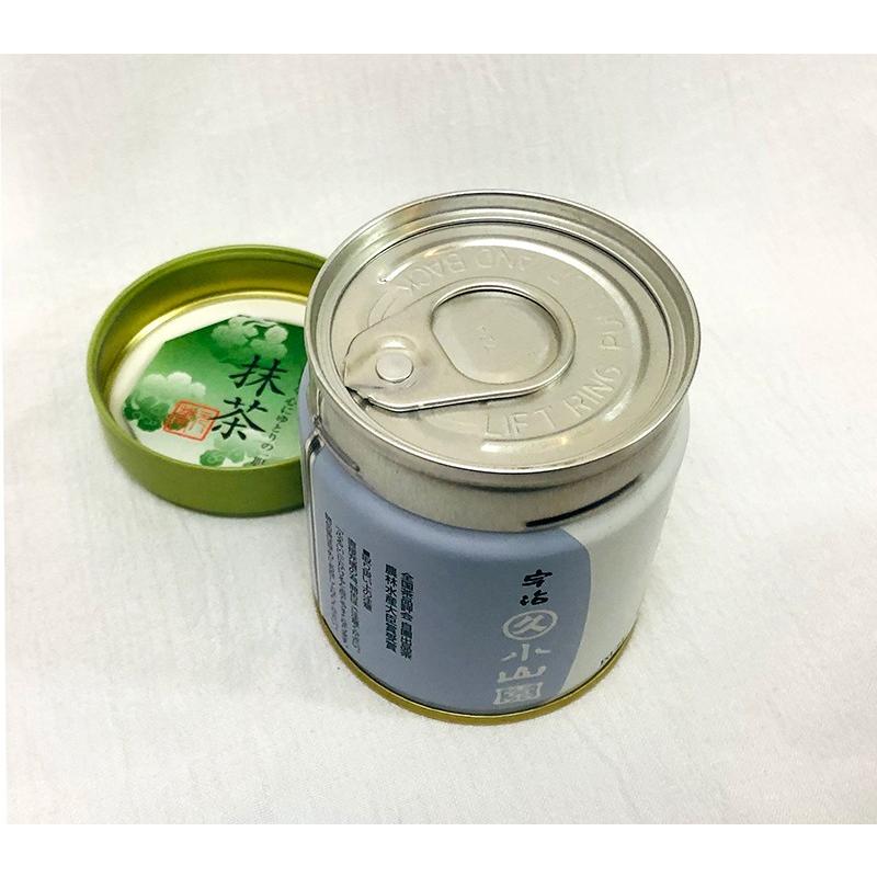 A small metal tin of matcha green tea with its green inner lid removed, showing the pull-tab metal top and the label on the can.