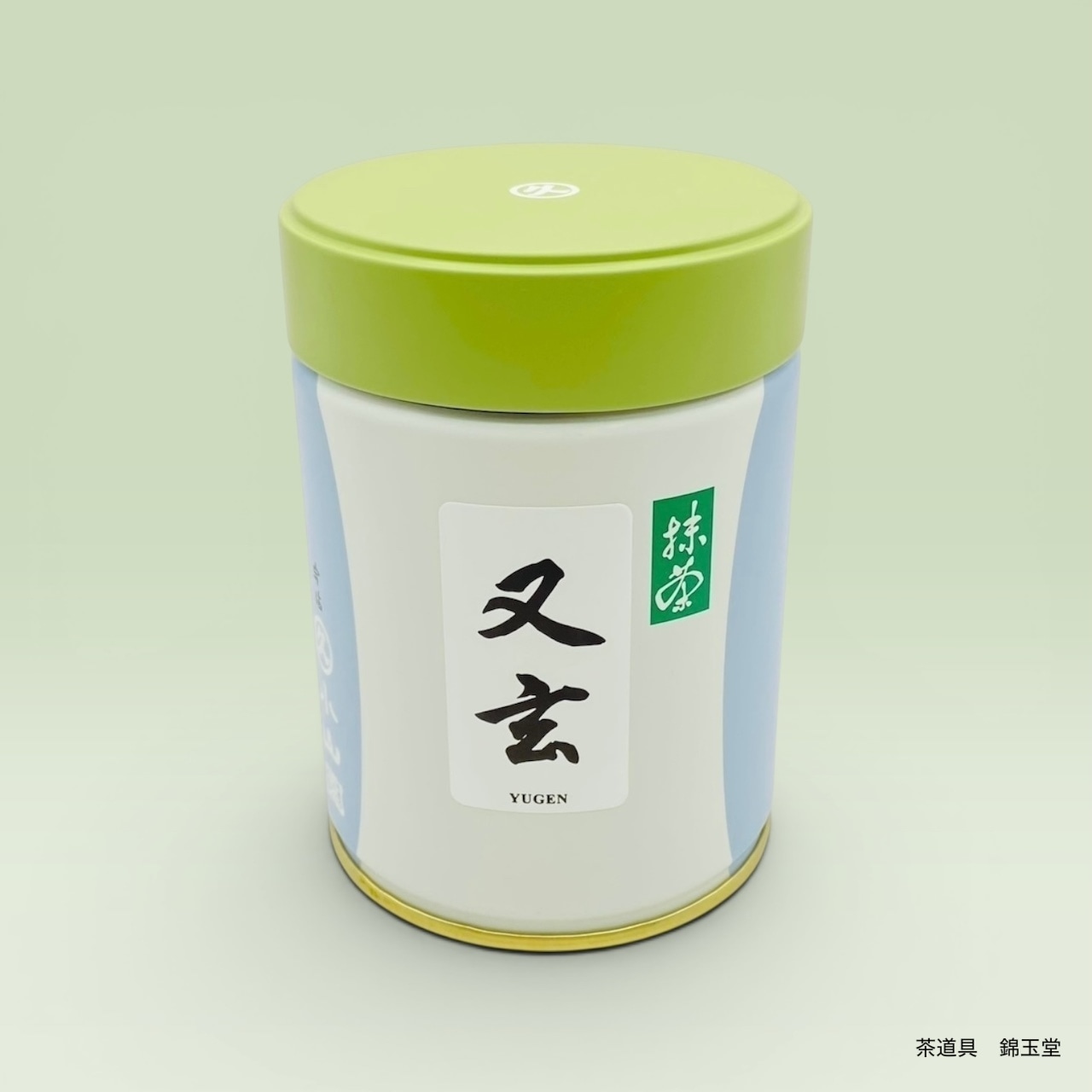 A green-lidded tin of Matcha Yugen (100g) with a white and light-blue label shown on a pale background.