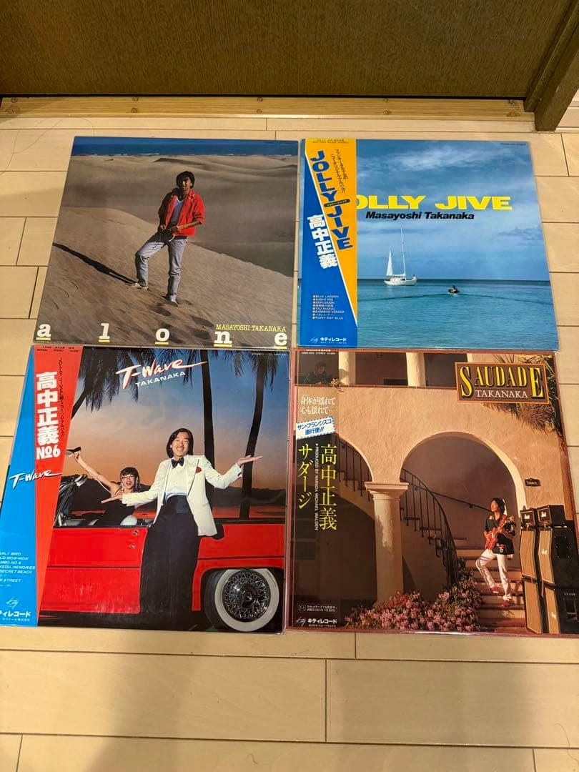 Four vinyl record sleeves from the 高中正義 original LP 4-disc set laid flat on the floor.