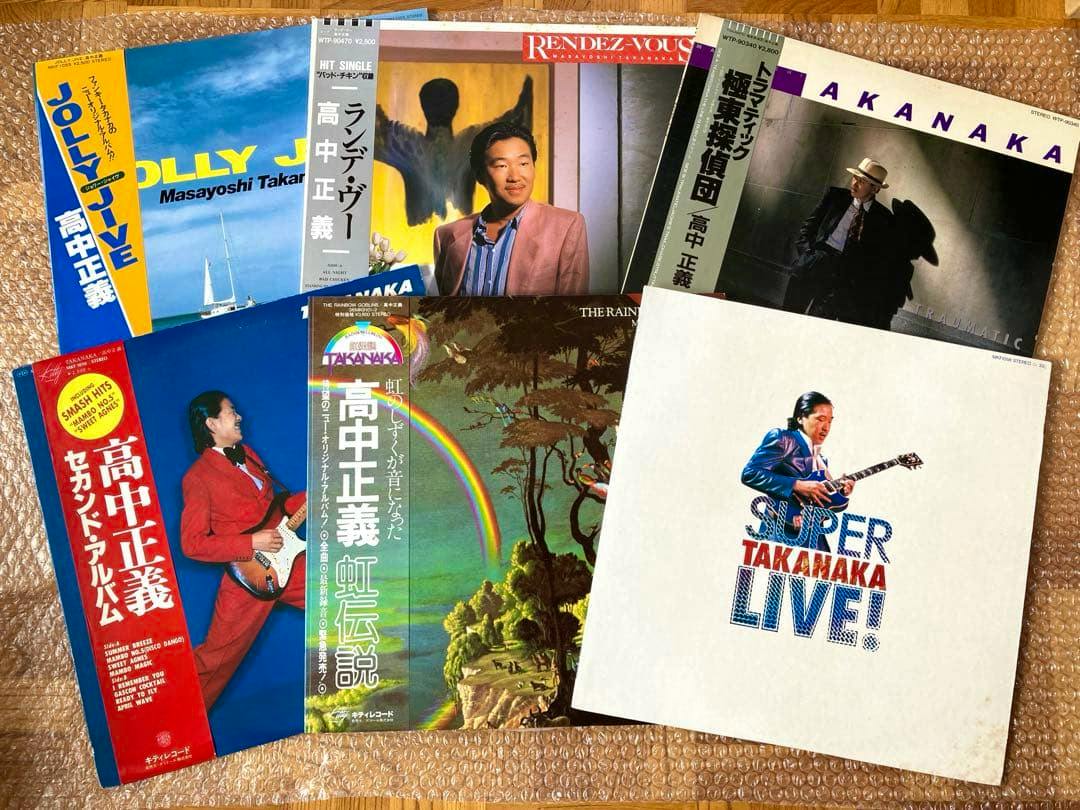 Six Masayoshi Takanaka LP record sleeves arranged on bubble wrap showing the album cover art.