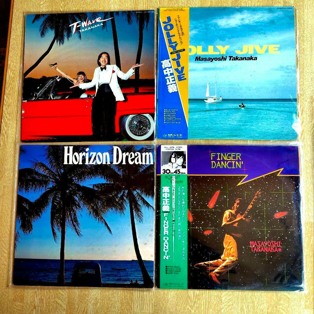 Four Masayoshi Takanaka vinyl record front covers arranged in a 2x2 grid on a wooden background.