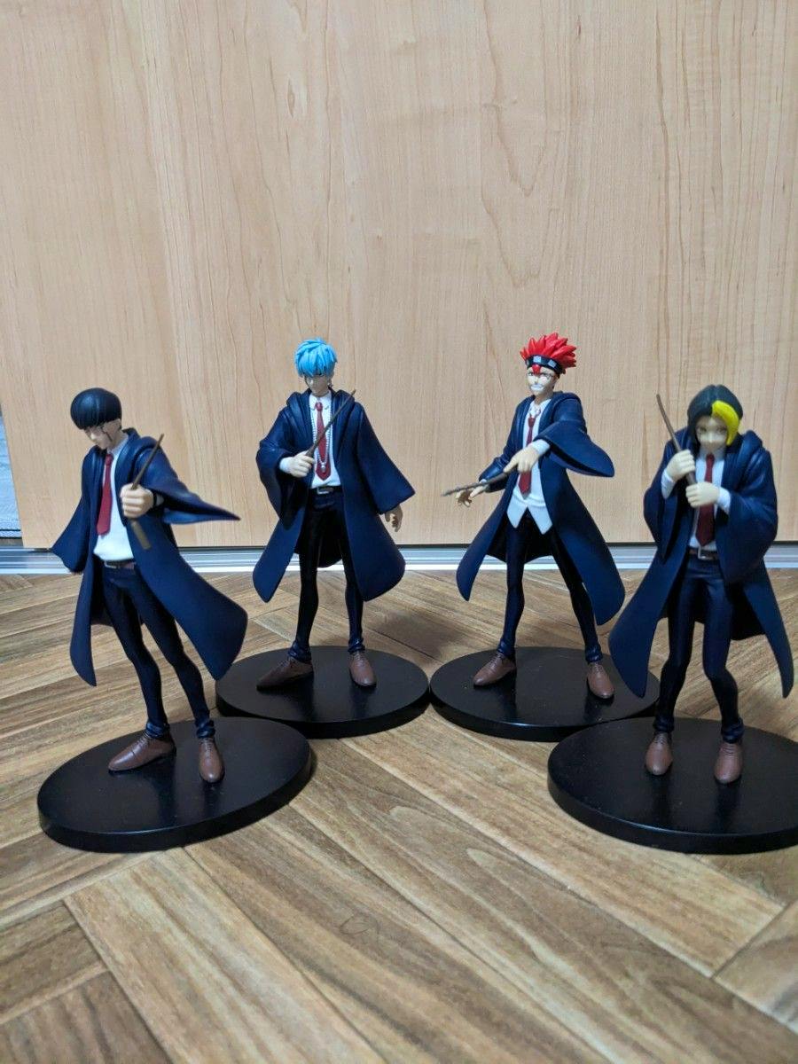 Four Mashle character figures on round black bases posed on a wooden floor with a wood-paneled background.