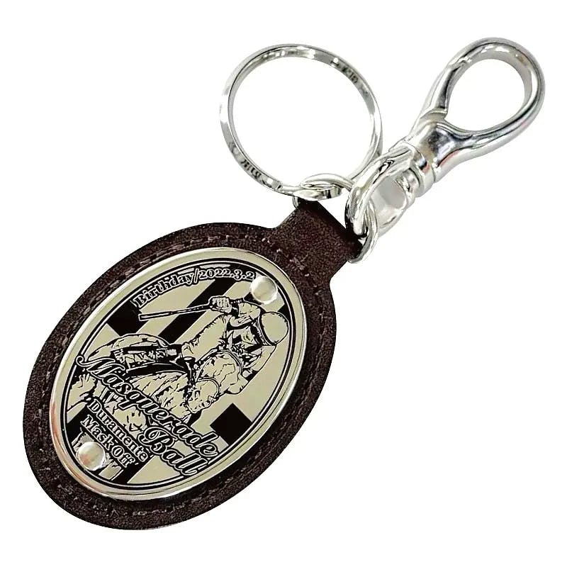 Front view of an oval cow leather keychain with a decorative metal plate, key ring, and lobster clasp.
