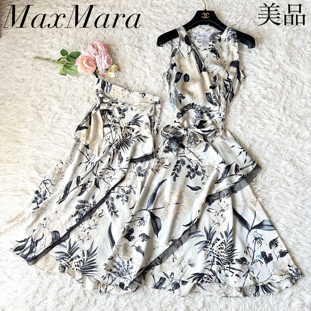 MaxMara floral long wrap dress set (dress and matching skirt) laid flat on a white faux-fur surface.