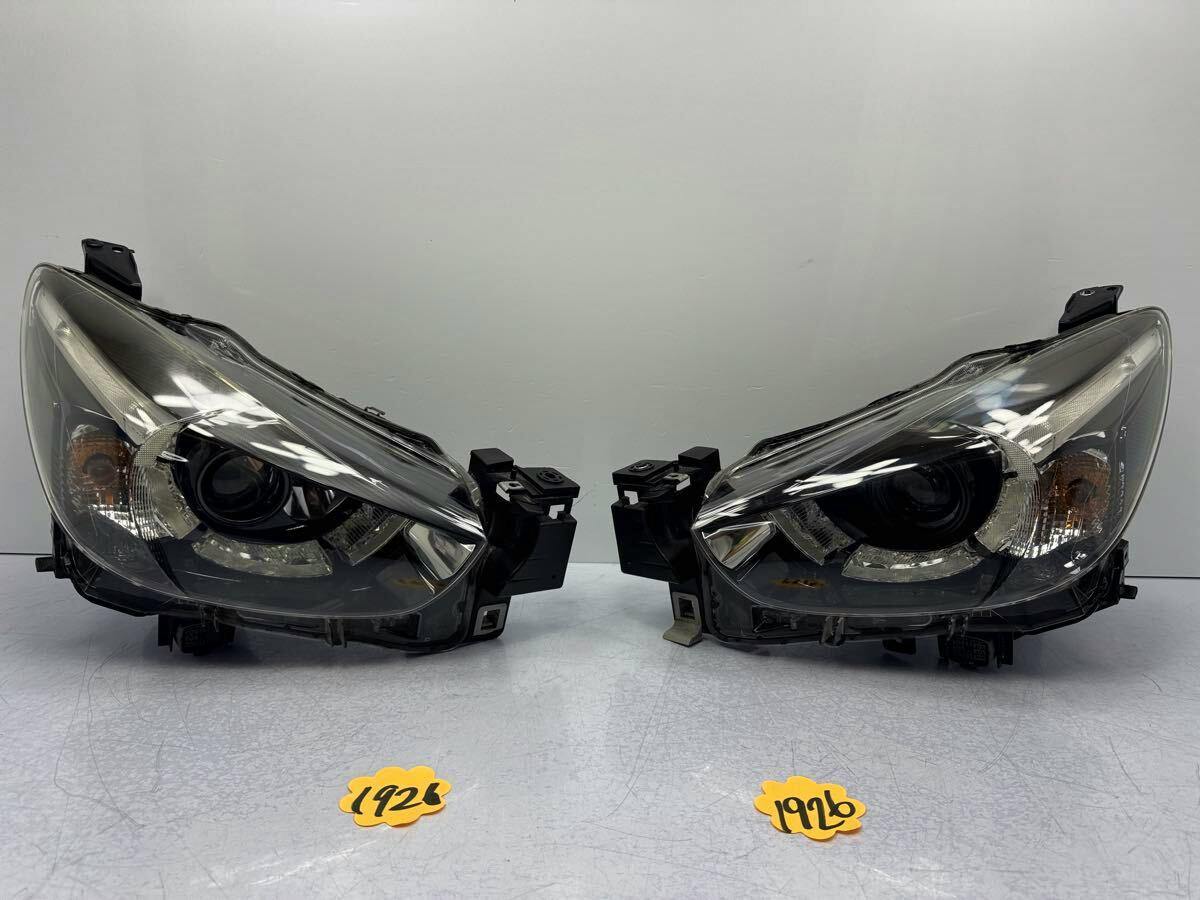 Front view of a left and right pair of Mazda Demio DJ5FS front headlights.