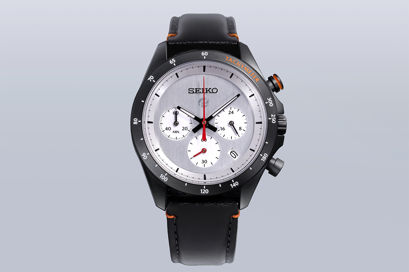 Front view of the MAZDA SPIRIT RACING chronograph watch showing a silver face, black bezel, and black leather strap.