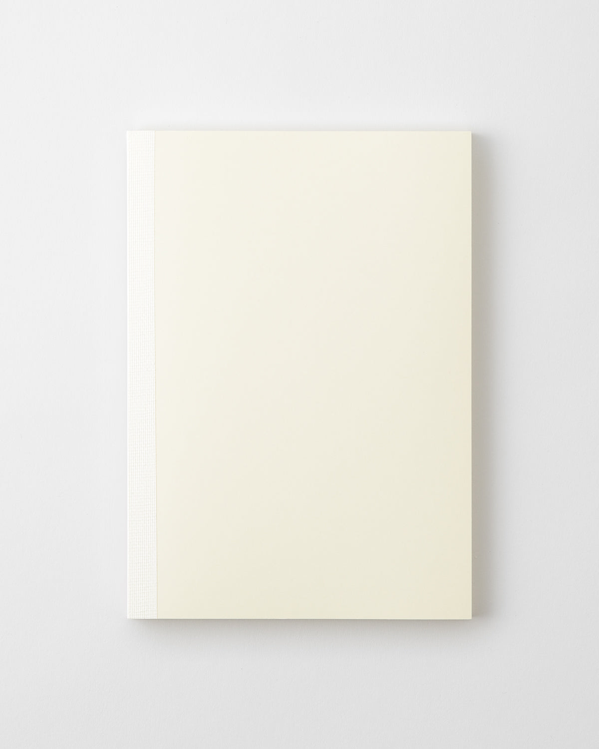 Top-down view of the MD Notebook (A5) showing a cream cover and white spine on a white background.