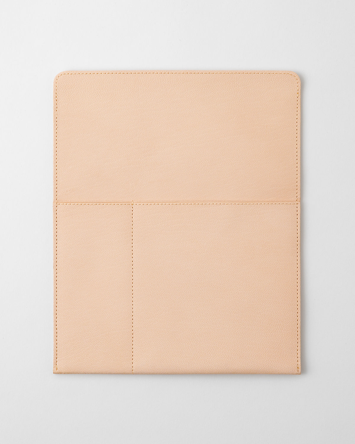 Front view of the vertical A5 MD notebook leather bag in light beige showing exterior pockets and stitching.