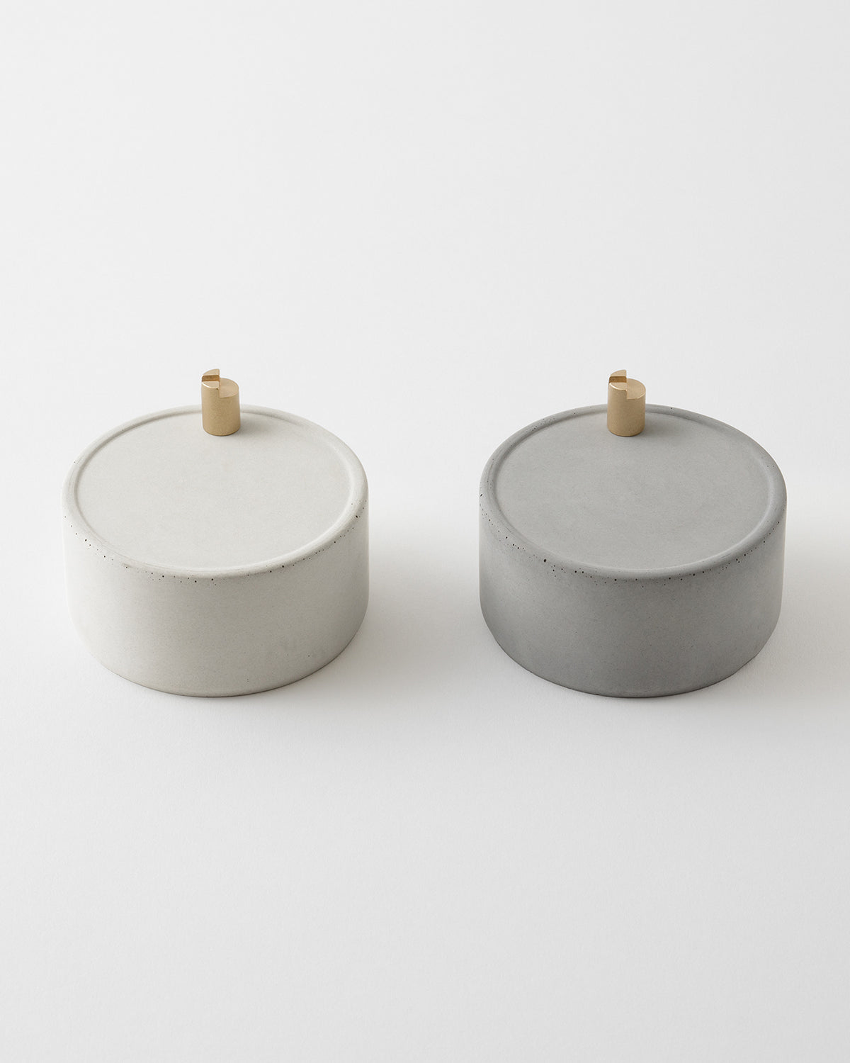 Two MD Scent Clock incense stand mortars, one light and one dark, shown on a white background.