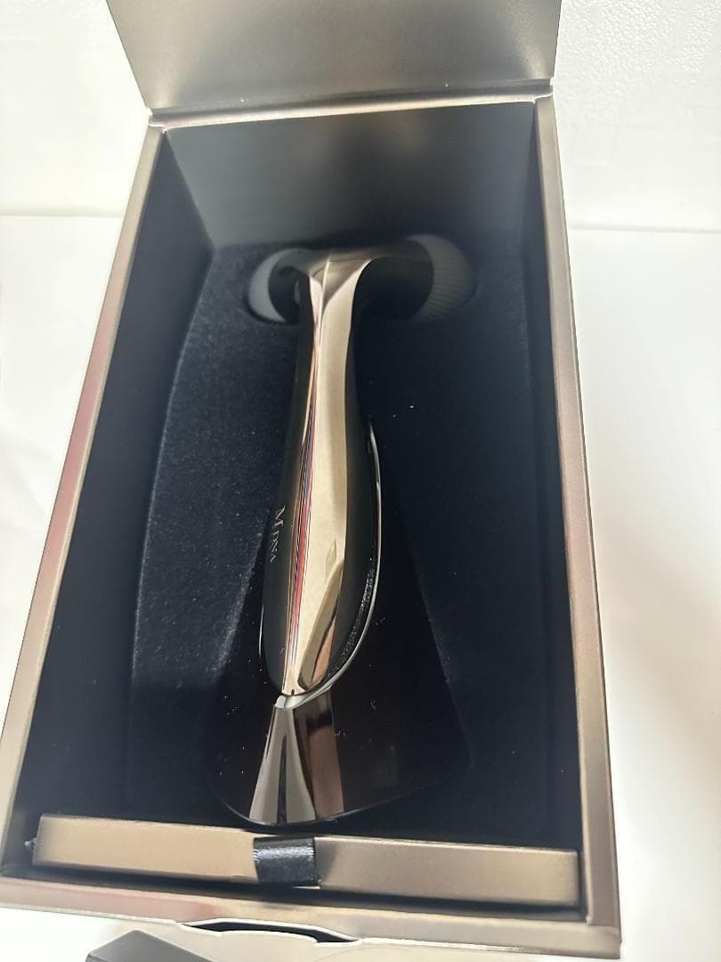 The MDNA SKIN ONYX BLACK facial roller positioned inside its box with foam lining.