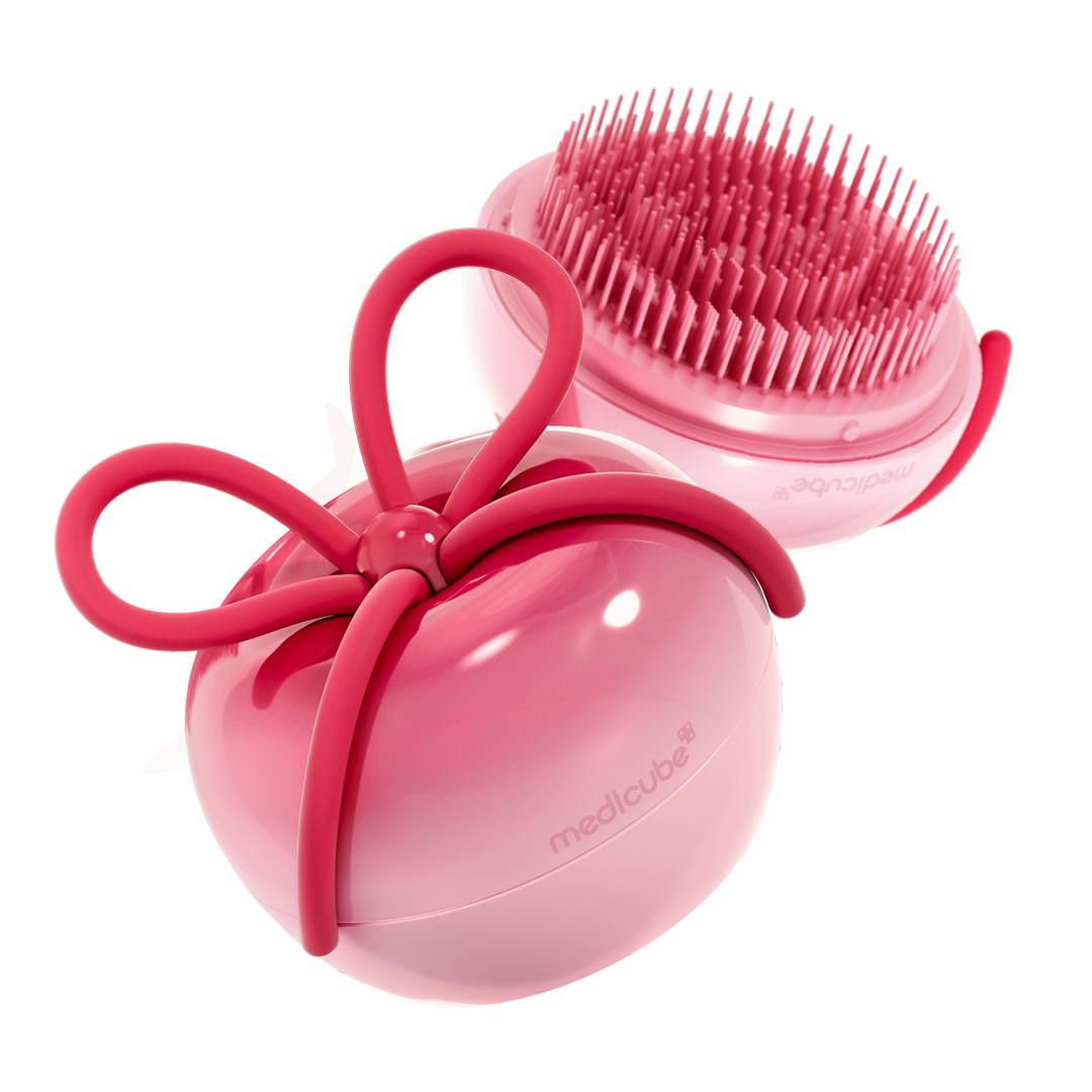 Pink ribbon-cherry handheld hair brush shown with its bristled head and decorative bow detail.