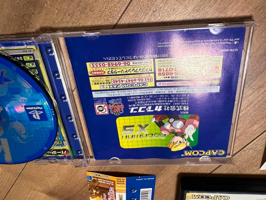 Overhead photo of the Rockman X5 PlayStation jewel case showing the game disc and back insert.