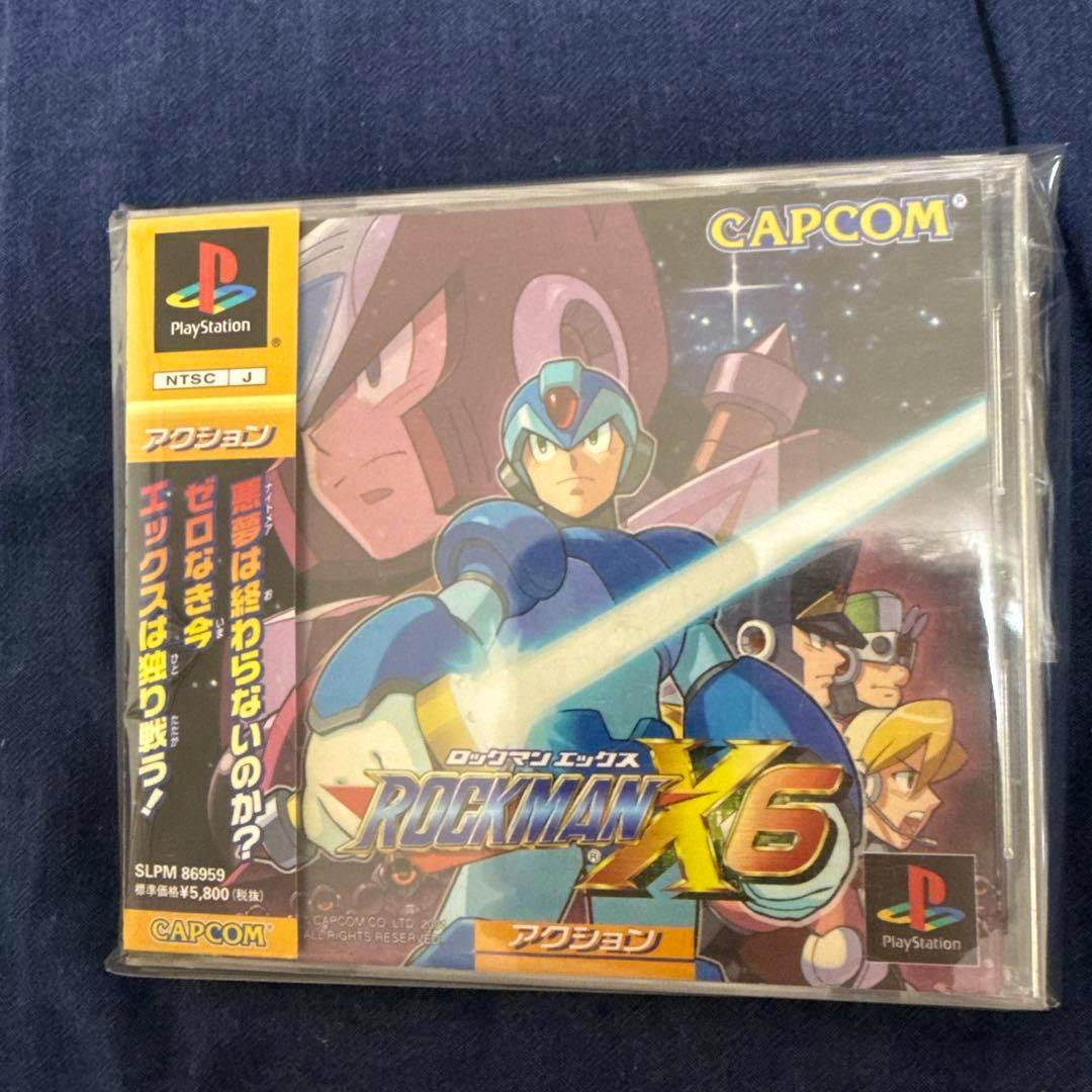 Front of the Japanese PlayStation jewel case for Rockman X6 showing the cover art, Capcom logo, and yellow obi strip.