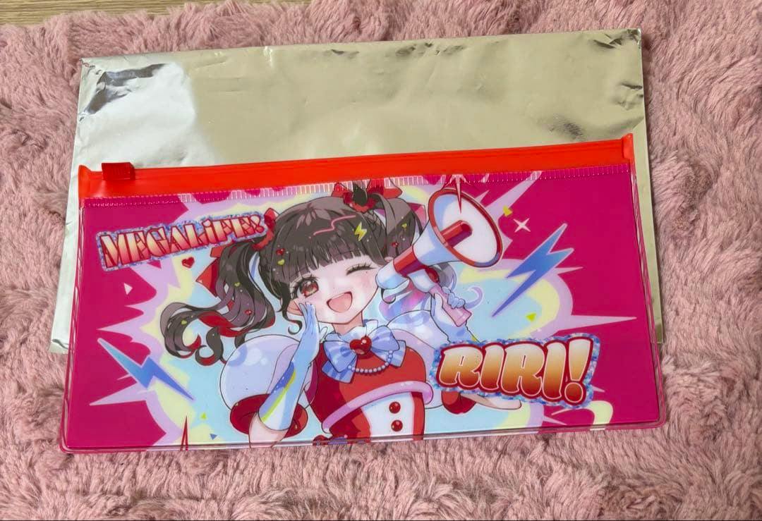 A pink MEGALiFE! RIRI! flat pouch printed with an illustrated girl holding a megaphone.