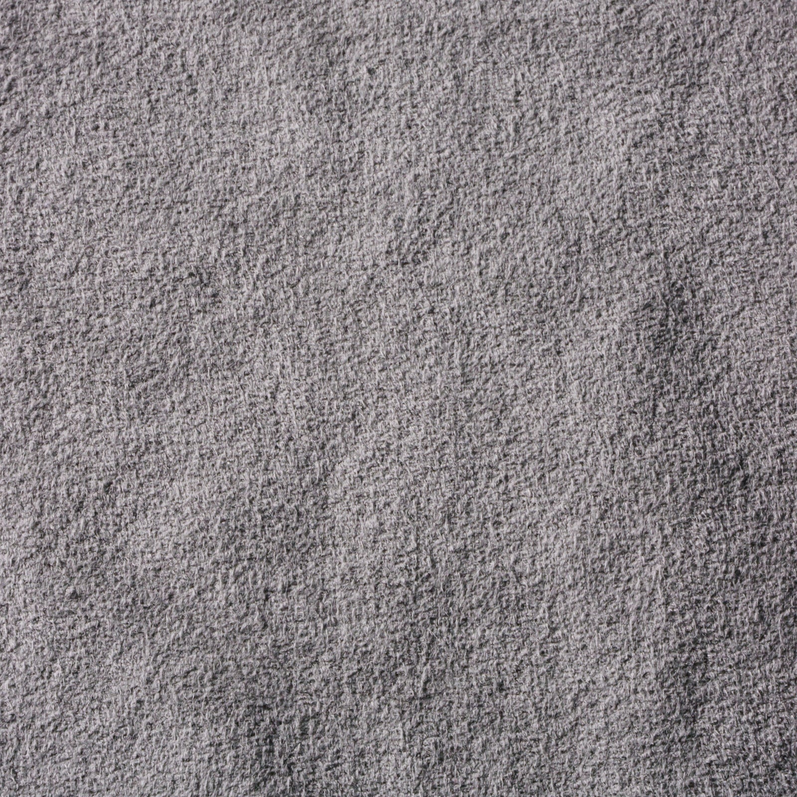 Close-up photo of melange gray synthetic micro-suede fabric showing its textured surface.