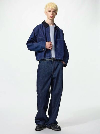 Front full-length photo of a model wearing dark blue baggy straight jeans.