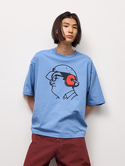Male model wearing a light blue boxy graphic men's cotton T-shirt.