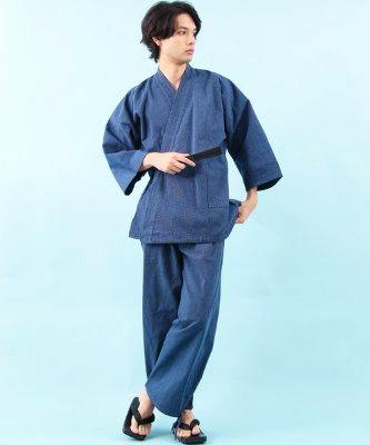 Male model wearing a blue cotton samue (traditional two-piece work garment) standing against a light blue background.