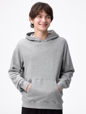 A gray men's sweatshirt hoodie worn by a smiling model, showing the front kangaroo pocket.