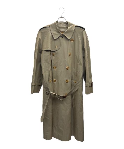 Beige men's trench coat with double-breasted buttons and a waist belt hanging on a hanger against a white background.