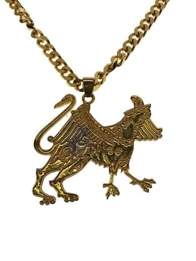 Close-up of a gold-tone stainless steel men's necklace pendant in a griffin design attached to a curb chain.