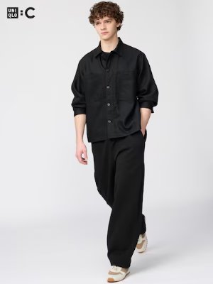 Male model wearing black wide sweat pants against a plain light background.