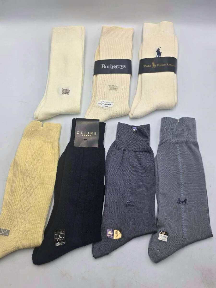 Seven men's socks (Polo Ralph Lauren, Burberry, Celine) arranged flat on a surface.