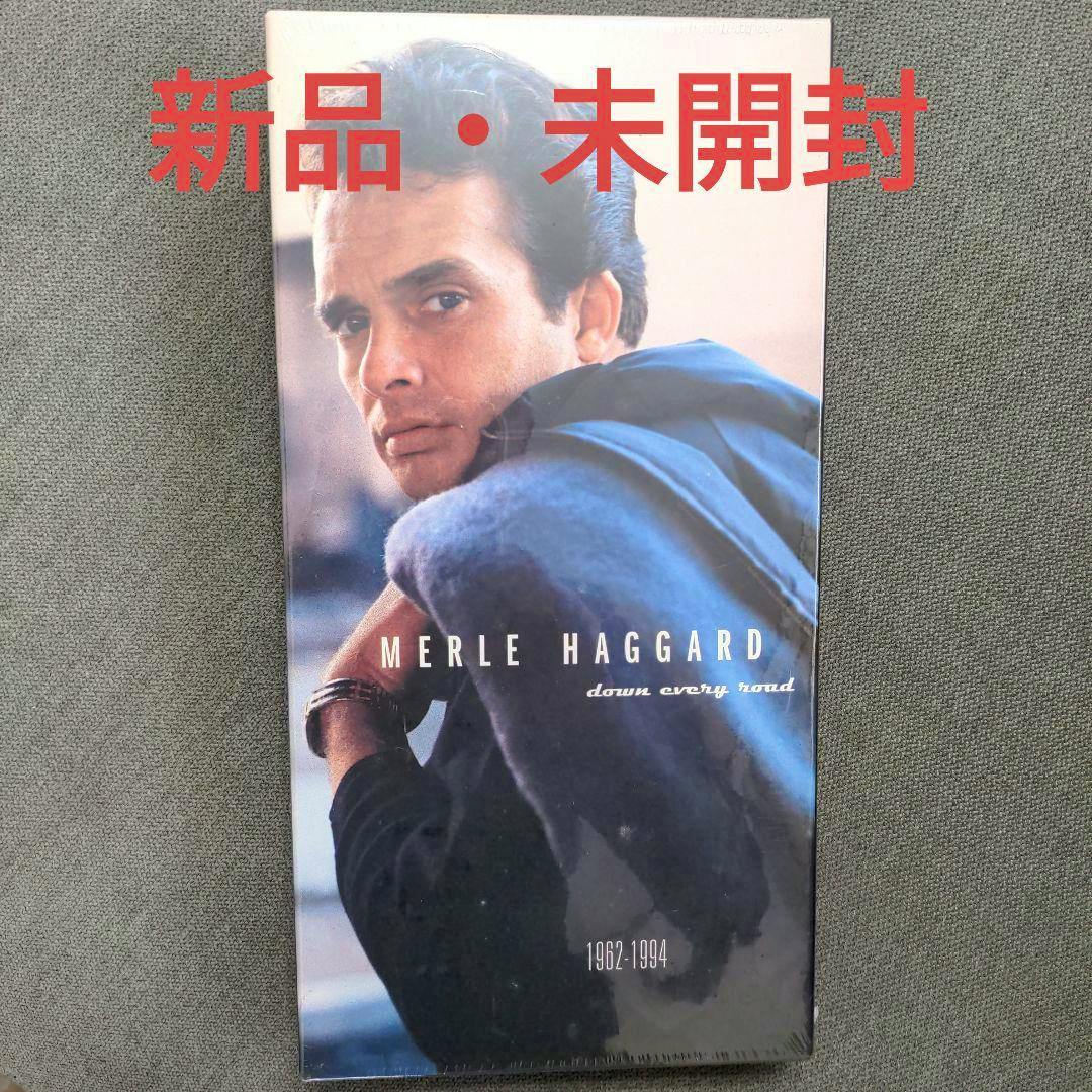 Front cover of the Merle Haggard "Down Every Road" CD showing the artist's portrait with red Japanese "new unopened" text overlaid.