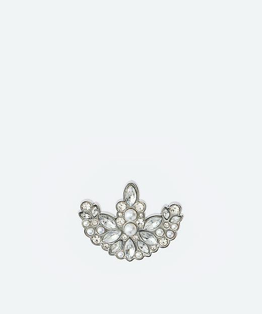 Front of a metal brooch showing clear teardrop and round stones with pearl-like beads arranged in a symmetrical fan shape on a white background.