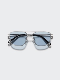 Front view of metal double-bridge sunglasses with blue-tinted lenses on a light background.