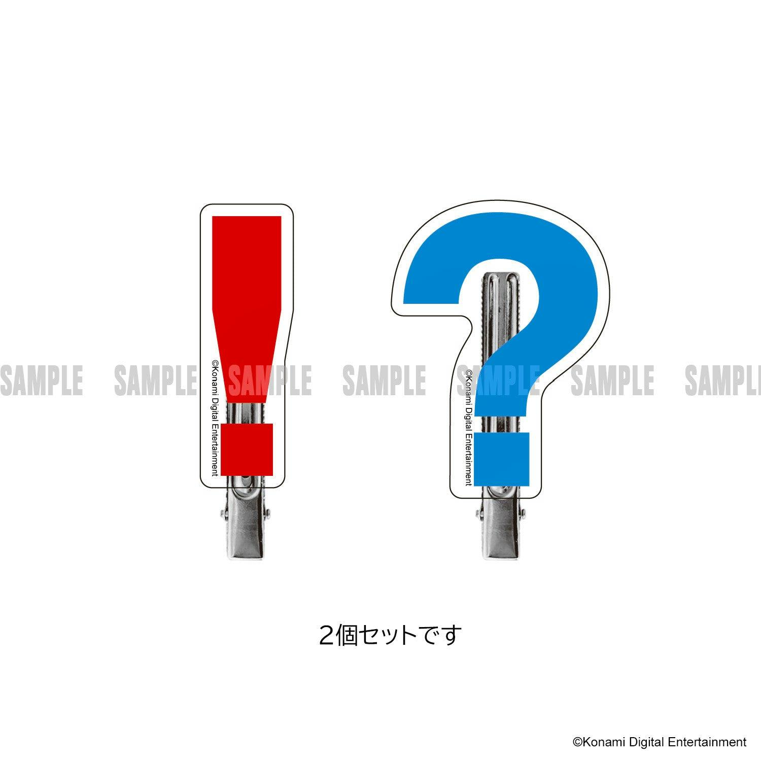 Two METAL GEAR SOLID bangs hair clips shaped as a red exclamation mark and a blue question mark attached to metal clips on a white background.